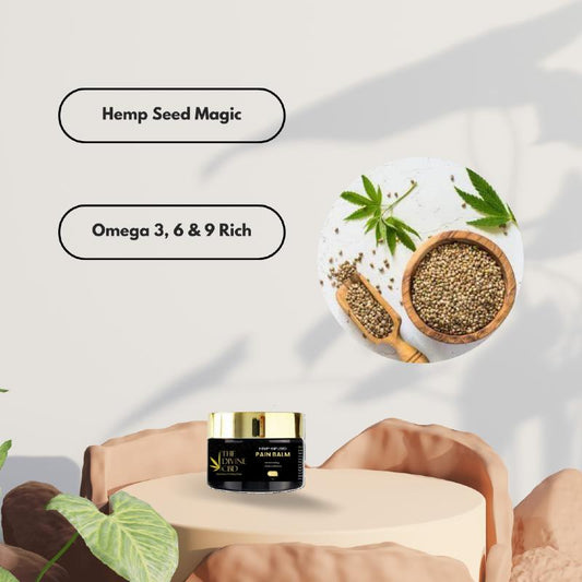 Pain balm jar with hemp seeds and leaves, labeled 'Hemp Seed Magic' and 'Omega 3, 6 & 9 Rich.'"