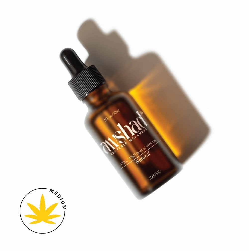 Amber glass dropper bottle of CBD oil with shadow, labeled "full-spectrum," 1500mg potency, with a "medium" leaf symbol.