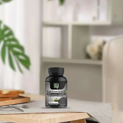 Black cumin seed oil bottle on a table with a blurred background