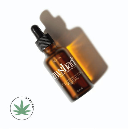 Amber glass dropper bottle with CBD oil, labeled "Sunshad Wellness," with a leaf symbol indicating medium strength.