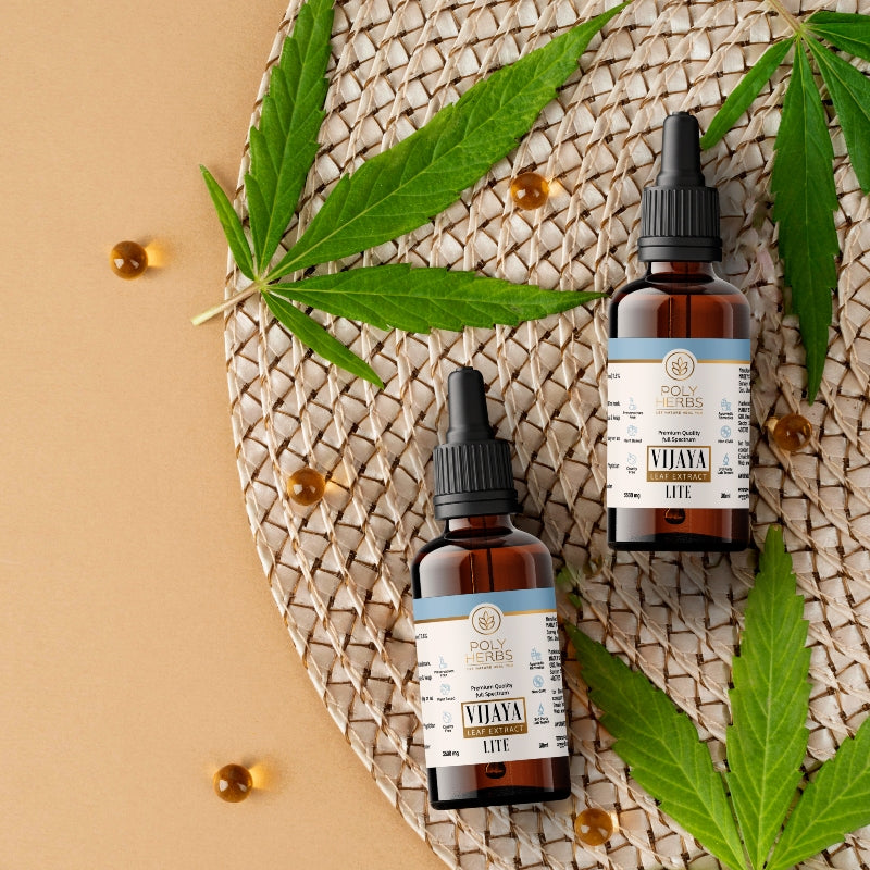 Two bottles of Vijaya Leaf Extract Bottle on a woven mat with cannabis leaves
