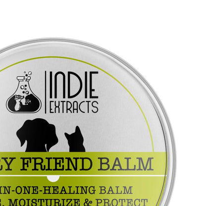 Lid of a silver tin container for Indie Extracts' pet balm, featuring brand name, silhouettes of a dog and cat, and product information.