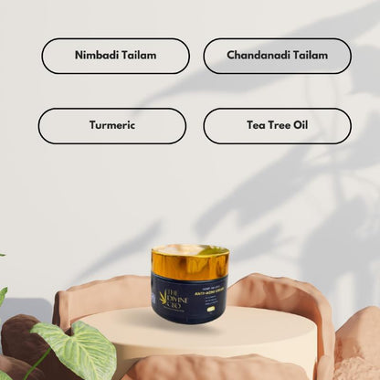 Anti-acne cream jar labeled "THE DIVINE CBD" displayed on a stone-like pedestal with ingredient names above.