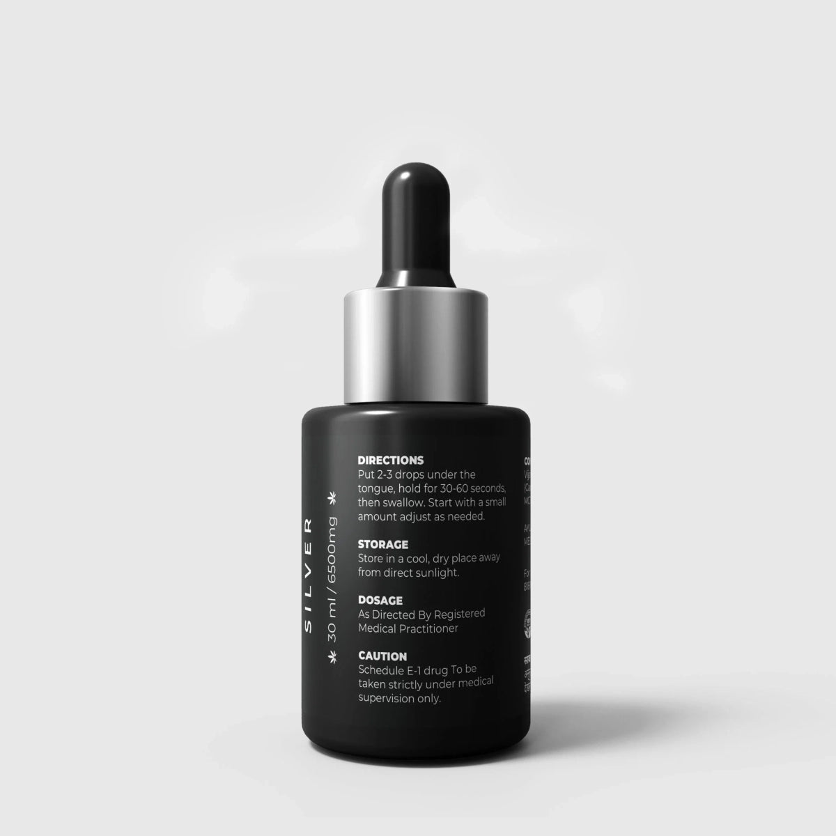 Black CBD Oil dropper bottle with silver cap on a light gray background