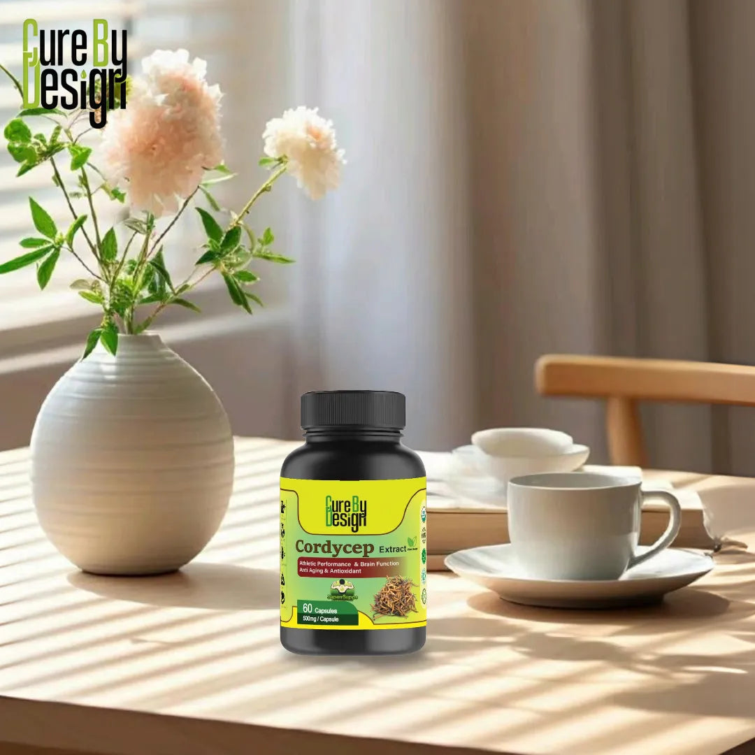 Cure By Design Cordyceps supplement bottle on a table with a vase of flowers and tea cups.