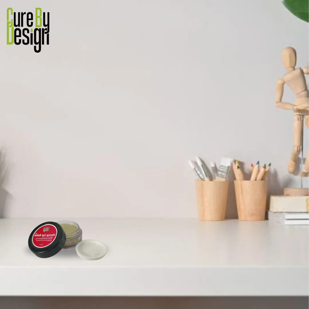 Small jar of cream on a white surface with 'Cure By Design' branding.