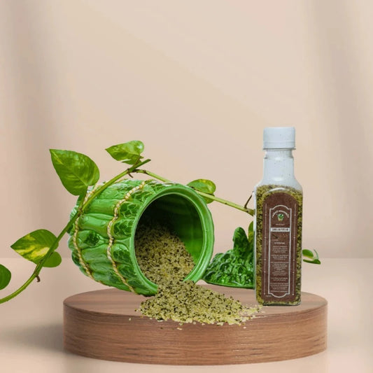 a green pot with a green plant and a bottle of hemp hearts from cannazo brand. 