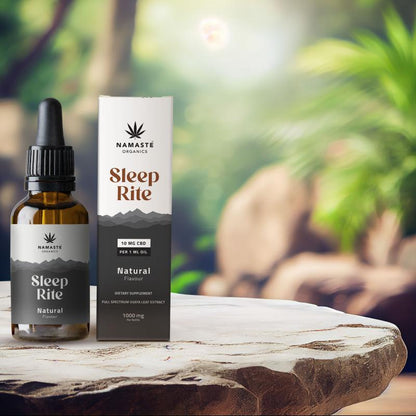 Namaste Organics Sleep Rite supplement bottle and packaging on a wooden surface with a natural background.