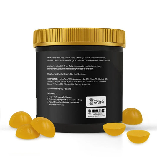 Black container with gold lid and yellow capsules on a white background