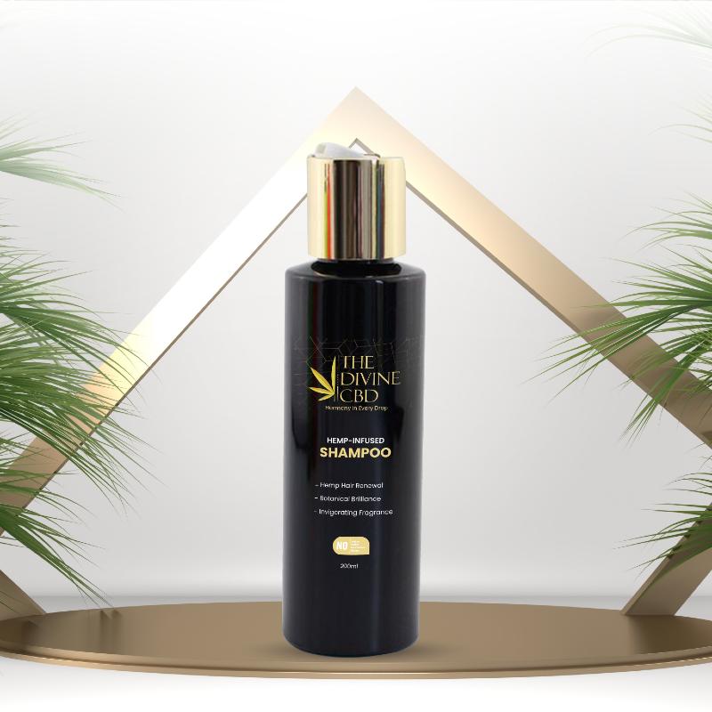 Black shampoo bottle with a gold cap, labeled "The Divine CBD Hemp-Infused Shampoo."

