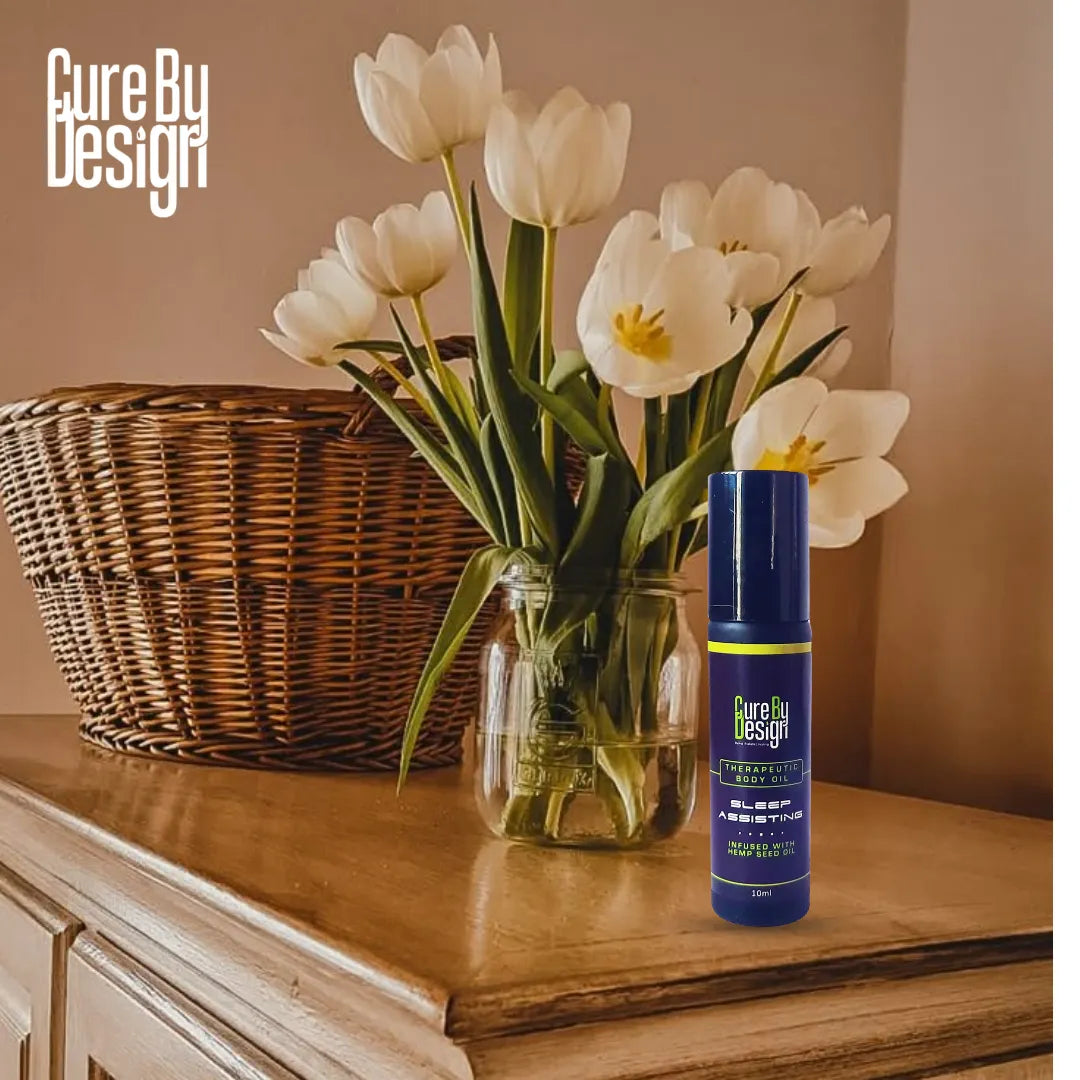 Cure By Design product on a wooden surface with white tulips in the background