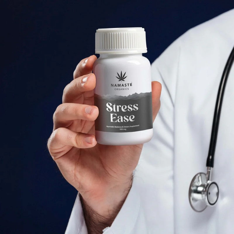 Person holding a bottle of Namaste Organics Stress Ease CBD supplement against a dark background